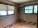 Simple bedroom with wood-look flooring, a window, and built-in shelving, perfect for storage at 106 N 300 W, Greenfield, IN 46140