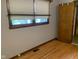 Bedroom featuring hardwood floors, a window with natural light, and neutral wall color, creating a cozy atmosphere at 106 N 300 W, Greenfield, IN 46140