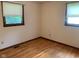 Bedroom with hardwood floors and two windows, perfect for creating a bright and comfortable space at 106 N 300 W, Greenfield, IN 46140