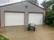 Metal clad outbuilding with two garage doors, decorative star and small wagon at 106 N 300 W, Greenfield, IN 46140
