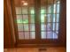 Elegant glass patio doors lead to sunroom with wood floors and natural light at 106 N 300 W, Greenfield, IN 46140