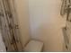 Bright tiled shower featuring a built in seat, hand rails, and adjustable shower head fixture at 106 N 300 W, Greenfield, IN 46140