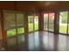 Bright sunroom with wood paneling, hardwood floors, and large windows overlooking the yard at 106 N 300 W, Greenfield, IN 46140