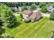 Aerial view of a home with a spacious yard and mature trees in a residential neighborhood at 11123 Garrick St, Fishers, IN 46038