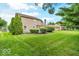 Large backyard with mature trees and landscaping at 11123 Garrick St, Fishers, IN 46038