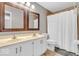 Bathroom with a double vanity, two mirrors, and a shower/tub combination at 11123 Garrick St, Fishers, IN 46038
