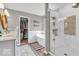 Bright bathroom featuring a modern shower, soaking tub, double vanity, and walk-in closet at 11123 Garrick St, Fishers, IN 46038