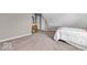 Bedroom with carpeted floors, neutral tones, a large window, and slanted walls at 11123 Garrick St, Fishers, IN 46038