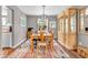 Bright dining room boasting hardwood floors, modern lighting, and elegant display case at 11123 Garrick St, Fishers, IN 46038