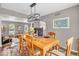 The dining room features hardwood floors, contemporary lighting, and seamless access to the living area at 11123 Garrick St, Fishers, IN 46038