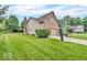 Side view of home featuring manicured lawn, trees, and basketball hoop at 11123 Garrick St, Fishers, IN 46038