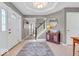 Inviting foyer showcases a wooden staircase, round mirror, and decorative furnishings at 11123 Garrick St, Fishers, IN 46038