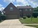 Charming two-story brick home with a well-manicured lawn and an attached two-car garage at 11123 Garrick St, Fishers, IN 46038
