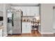 Bright kitchen with stainless fridge, white cabinets, granite counters, and a convenient desk area at 11123 Garrick St, Fishers, IN 46038
