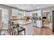 Spacious kitchen boasts white cabinets, stainless appliances, breakfast bar, and hardwood flooring at 11123 Garrick St, Fishers, IN 46038