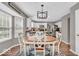 Charming kitchen boasts white cabinets, stainless appliances, and eat-in breakfast nook with natural light at 11123 Garrick St, Fishers, IN 46038