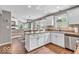 Bright kitchen with a granite countertop, a central island, and white cabinets at 11123 Garrick St, Fishers, IN 46038