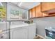 Bright laundry area with white washer and dryer, plus ample cabinet storage space at 11123 Garrick St, Fishers, IN 46038