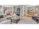 Open-concept living room with plush seating, gray walls, and a seamless transition to other living spaces at 11123 Garrick St, Fishers, IN 46038