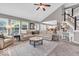 Inviting living room features vaulted ceilings, large windows, and seamless flow to kitchen at 11123 Garrick St, Fishers, IN 46038