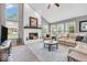 Bright living room features a fireplace, large windows, and comfortable seating at 11123 Garrick St, Fishers, IN 46038