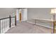 Upstairs loft area with neutral carpet and paint, plus white trim and a desk at 11123 Garrick St, Fishers, IN 46038