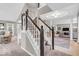 Elegant staircase leading to the upper level, showcasing open layout and natural light at 11123 Garrick St, Fishers, IN 46038