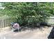 Backyard concrete patio with a chair, surrounded by a fence and large tree at 126 Old Farm Rd, Danville, IN 46122