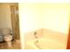 Bathroom featuring a corner tub, toilet, and glass-enclosed shower at 126 Old Farm Rd, Danville, IN 46122