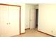 Bedroom featuring neutral carpet, baseboards and paint, with access to closet at 126 Old Farm Rd, Danville, IN 46122
