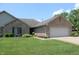 Charming single-story home featuring a brick facade, well-manicured lawn, and an attached two-car garage at 126 Old Farm Rd, Danville, IN 46122