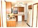 Functional kitchen with wood cabinets, appliances, and a window providing natural light at 126 Old Farm Rd, Danville, IN 46122