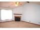 Inviting living room with a vaulted ceiling, neutral carpet, and a cozy fireplace with a mantel at 126 Old Farm Rd, Danville, IN 46122