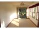 Sun-filled room featuring carpet flooring, large windows, and a sliding door to the outside at 126 Old Farm Rd, Danville, IN 46122