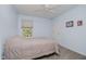 Cozy bedroom featuring soft blue walls, carpet floors, and a light-filled window for a peaceful retreat at 13214 Dunwoody Ln, Carmel, IN 46033