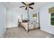Bright bedroom with carpet flooring, a window, and a four-poster bed at 13214 Dunwoody Ln, Carmel, IN 46033