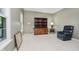 Bedroom with neutral walls, carpet, a large bookcase, and an accent chair at 13214 Dunwoody Ln, Carmel, IN 46033