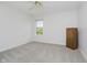 A minimalist bedroom featuring plush carpet, a window, and a cabinet at 13214 Dunwoody Ln, Carmel, IN 46033