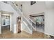 Inviting foyer featuring a staircase, wood floors, and view into the formal dining room at 13214 Dunwoody Ln, Carmel, IN 46033