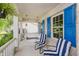 Charming front porch with blue shutters, swing, and striped chairs offers a relaxing outdoor space at 13214 Dunwoody Ln, Carmel, IN 46033