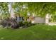 Landscaped front yard of a two story home, showing mature trees and green lawn at 13214 Dunwoody Ln, Carmel, IN 46033