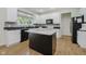 Bright kitchen features white cabinets, granite counters, stainless steel appliances, and center island at 13214 Dunwoody Ln, Carmel, IN 46033