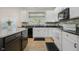 Bright kitchen with stainless steel appliances, granite counters, and undermount sink with modern faucet at 13214 Dunwoody Ln, Carmel, IN 46033