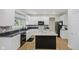 Bright kitchen features white cabinets, granite counters, stainless steel appliances, and center island at 13214 Dunwoody Ln, Carmel, IN 46033