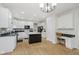 Modern kitchen with white cabinets, stainless steel appliances, and an island with a seating area at 13214 Dunwoody Ln, Carmel, IN 46033