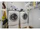 Laundry room with newer side-by-side washer and dryer and wire shelving for plenty of storage at 13214 Dunwoody Ln, Carmel, IN 46033