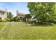 The large backyard features well maintained green grass and a flower garden at 13470 Shakamac Dr, Carmel, IN 46032