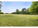 Large backyard featuring a lush green lawn and mature trees providing a beautiful open space at 13470 Shakamac Dr, Carmel, IN 46032