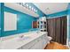 Bright bathroom with a double vanity, modern lighting, and ample storage space at 13470 Shakamac Dr, Carmel, IN 46032