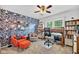 Inviting home office features a blue patterned accent wall, built-in shelving, and a cozy reading nook at 13470 Shakamac Dr, Carmel, IN 46032